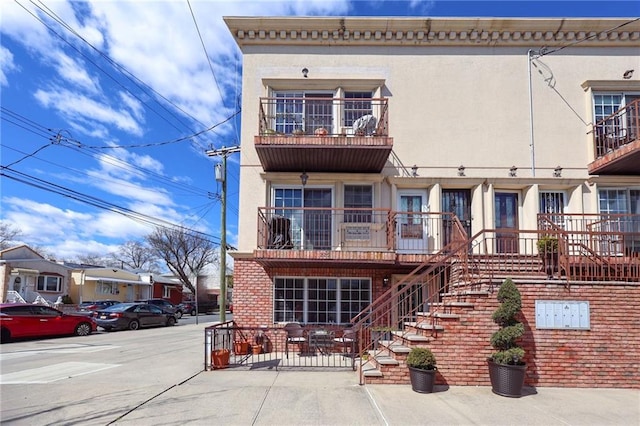 view of front of house with stucco siding and a patio