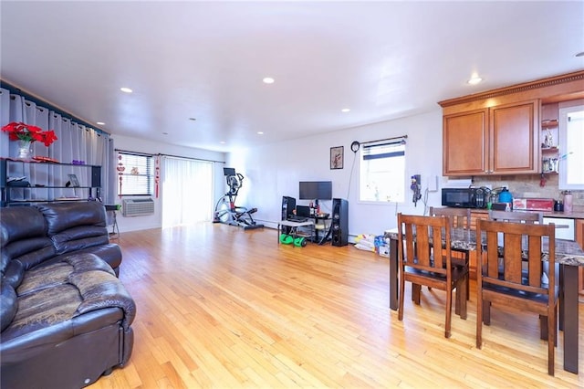 living room featuring a healthy amount of sunlight and light hardwood / wood-style flooring