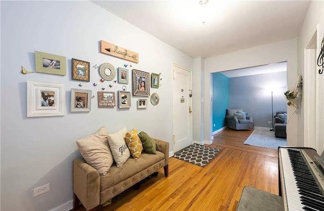 interior space featuring baseboards and light wood finished floors