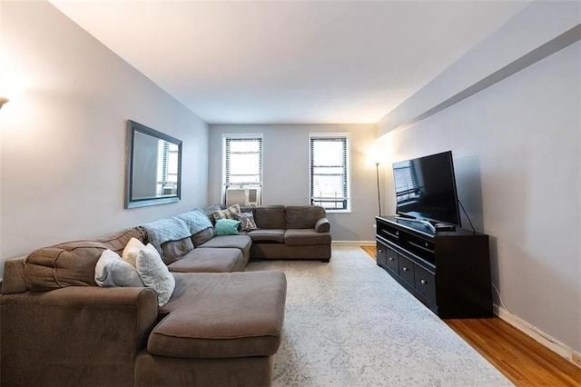 living area with light wood finished floors and baseboards