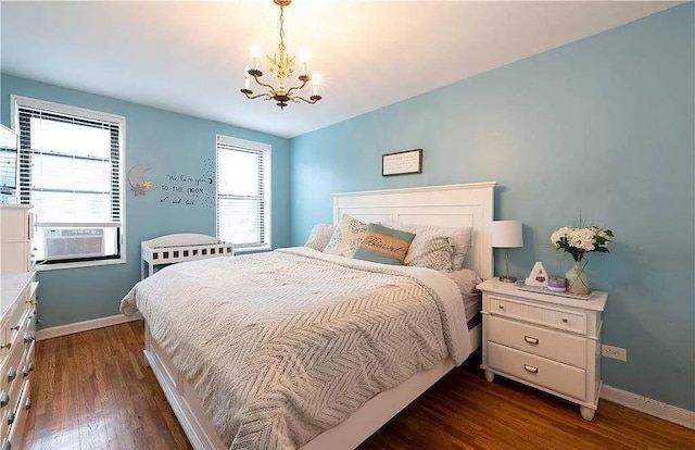 bedroom with a chandelier, baseboards, and dark wood-style floors