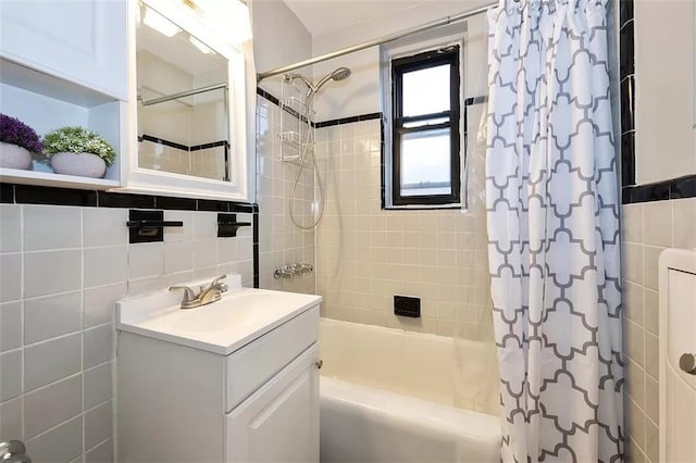 bathroom featuring tile walls, vanity, and shower / bath combo