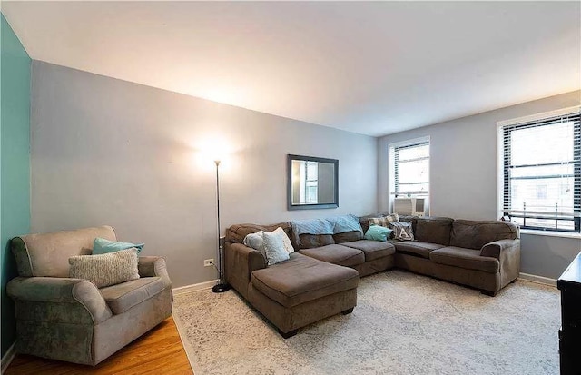 living room featuring baseboards and light wood-style flooring