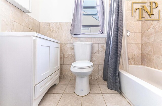 bathroom with tile walls, shower / tub combo, tile patterned floors, and toilet