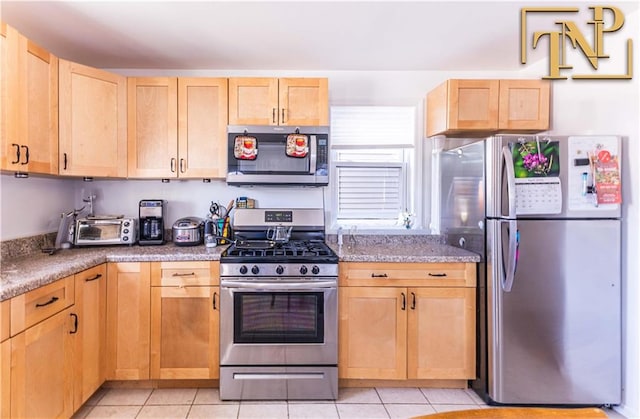 14 Webers Ct, Brooklyn, NY 11235 - kitchen featuring stainless steel appliances, light brown cabinetry, and light tile patterned floors