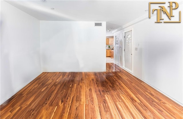 unfurnished room featuring hardwood / wood-style floors