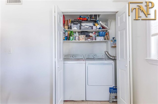 laundry room featuring washer and dryer and light tile patterned floors