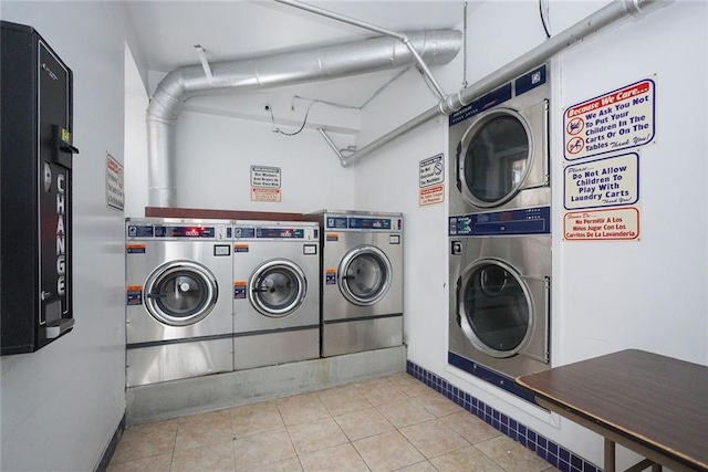 common laundry area with tile patterned flooring, washing machine and clothes dryer, and stacked washing maching and dryer