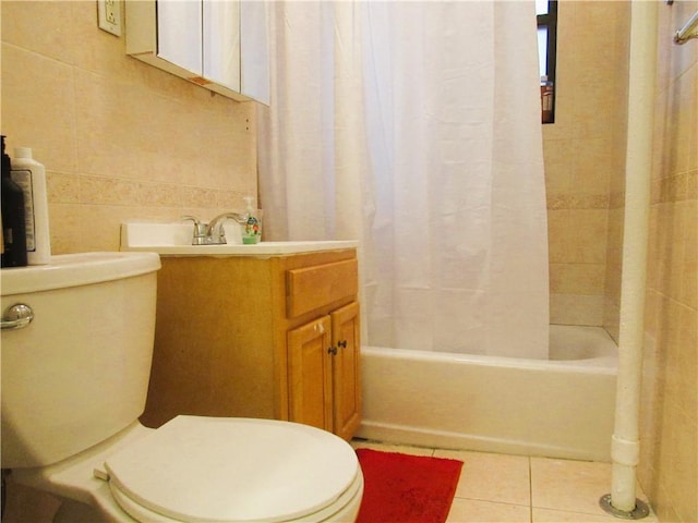 full bathroom with shower / tub combo with curtain, toilet, tile walls, vanity, and tile patterned flooring