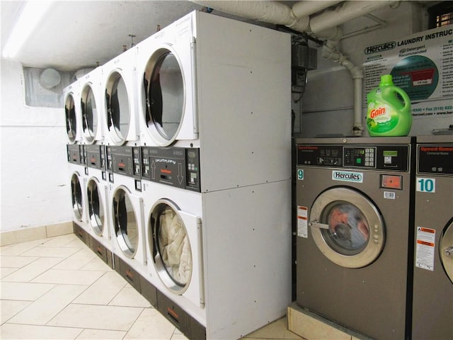 laundry room featuring stacked washer / dryer, light tile patterned flooring, and separate washer and dryer