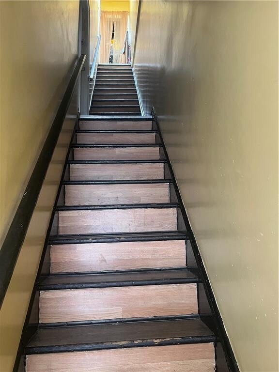 staircase with wood-type flooring