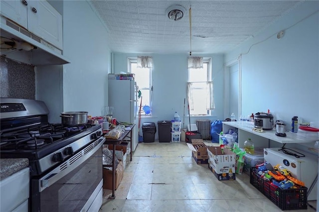 kitchen with white cabinets, gas range, white refrigerator, and decorative light fixtures