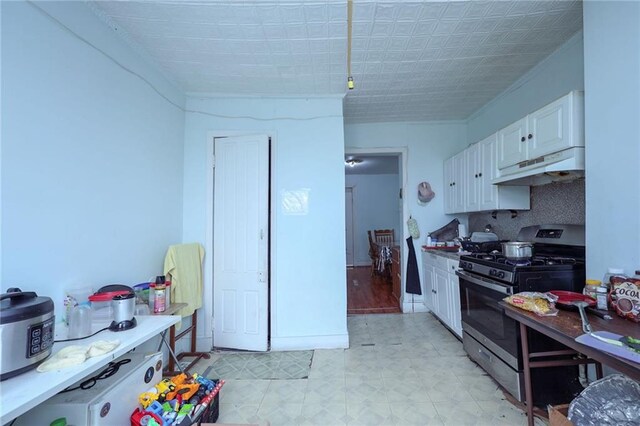 kitchen featuring white cabinets and stainless steel range with gas stovetop