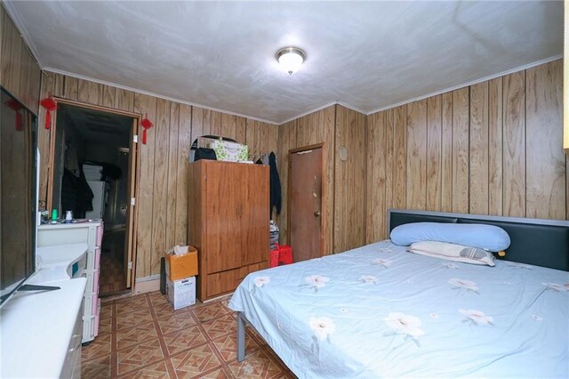 bedroom featuring wood walls