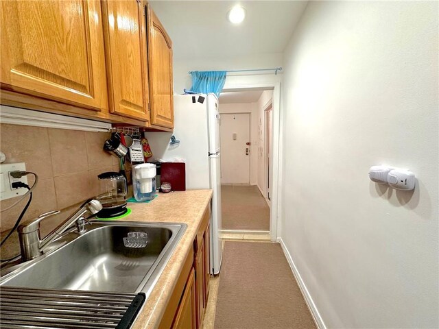 kitchen with white refrigerator and sink