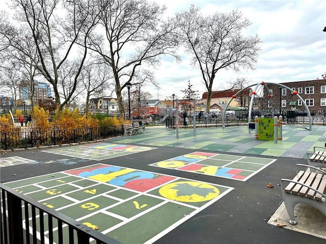 view of home's community featuring basketball hoop