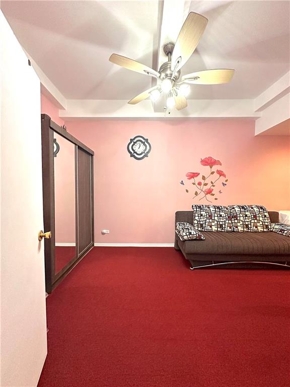 interior space with ceiling fan and carpet flooring