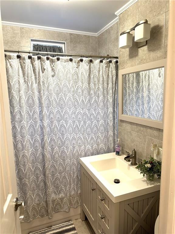 bathroom featuring vanity, crown molding, tile walls, and shower / tub combo with curtain