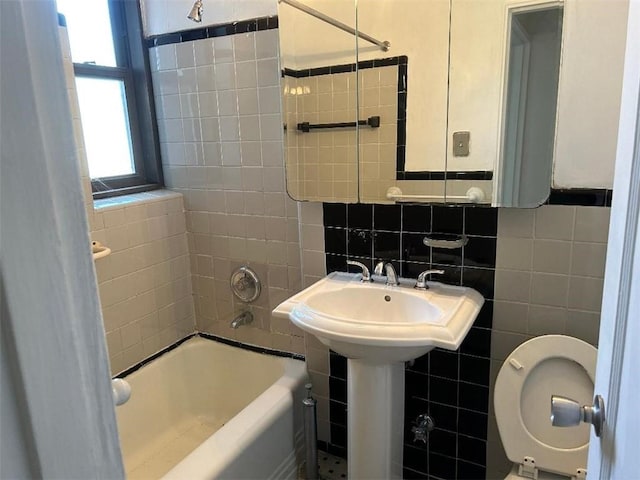 full bathroom featuring shower / tub combination, tile walls, and toilet