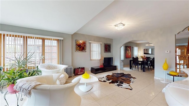 living room featuring radiator heating unit and light tile patterned floors