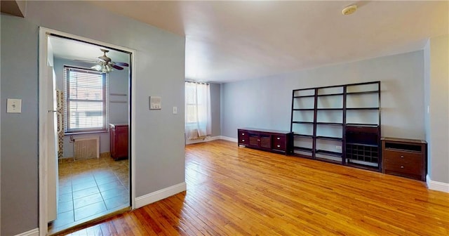 1934 Haring St, Brooklyn, NY 11229 - unfurnished room with baseboards, plenty of natural light, a ceiling fan, and hardwood / wood-style floors