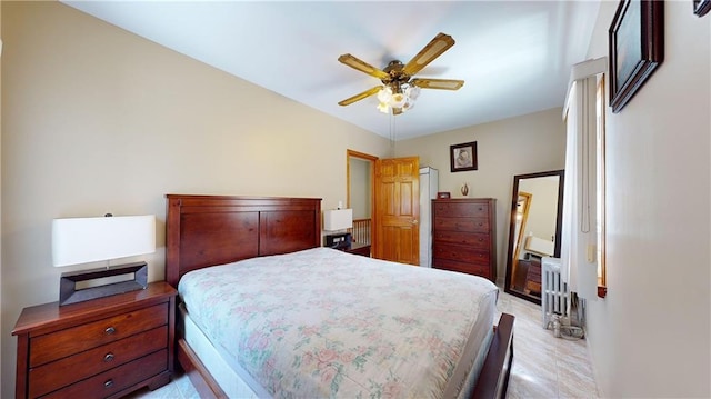 bedroom with ceiling fan and radiator heating unit