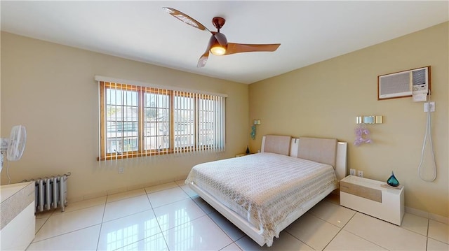 bedroom featuring light tile patterned flooring, a wall mounted air conditioner, radiator, and ceiling fan