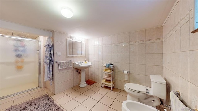 bathroom with a bidet, tile patterned floors, toilet, tile walls, and a shower with shower door