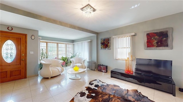 living room featuring radiator heating unit and light tile patterned floors