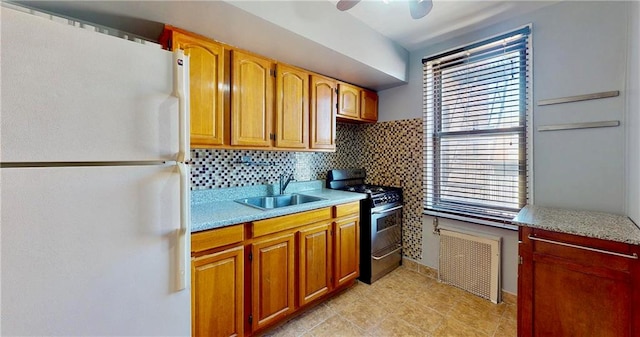 1934 Haring St, Brooklyn, NY 11229 - kitchen with freestanding refrigerator, a sink, gas stove, and light countertops