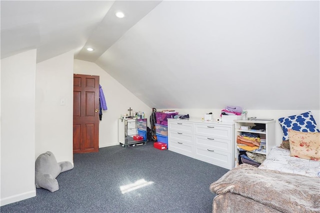 bedroom with lofted ceiling and dark carpet