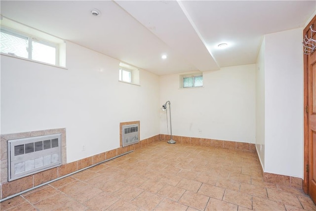 basement featuring heating unit and a fireplace