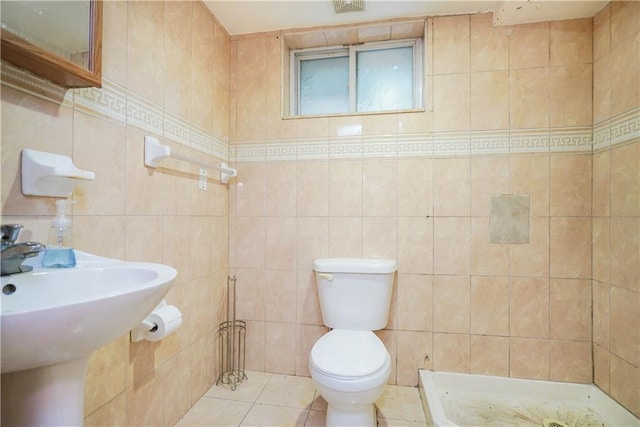 bathroom featuring walk in shower, tile walls, toilet, and tile patterned floors