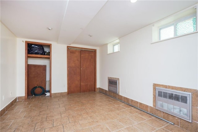 interior space featuring heating unit and a closet