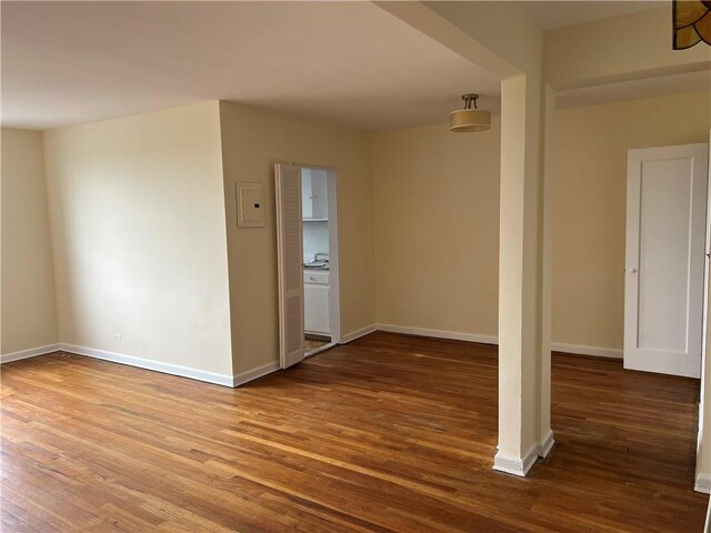 empty room with hardwood / wood-style flooring