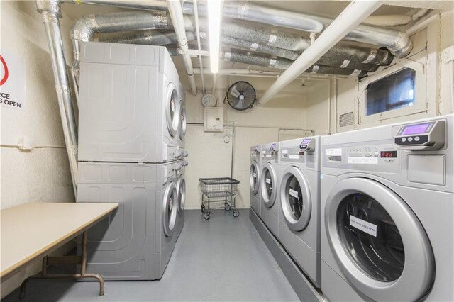 clothes washing area featuring stacked washer / drying machine