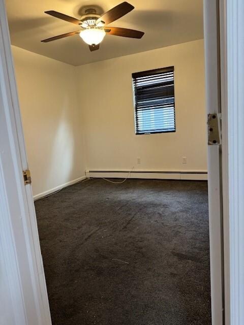 living room featuring stacked washer / drying machine, light hardwood / wood-style flooring, and ceiling fan