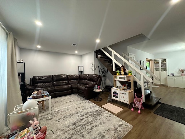 living area featuring recessed lighting, visible vents, wood finished floors, and stairs