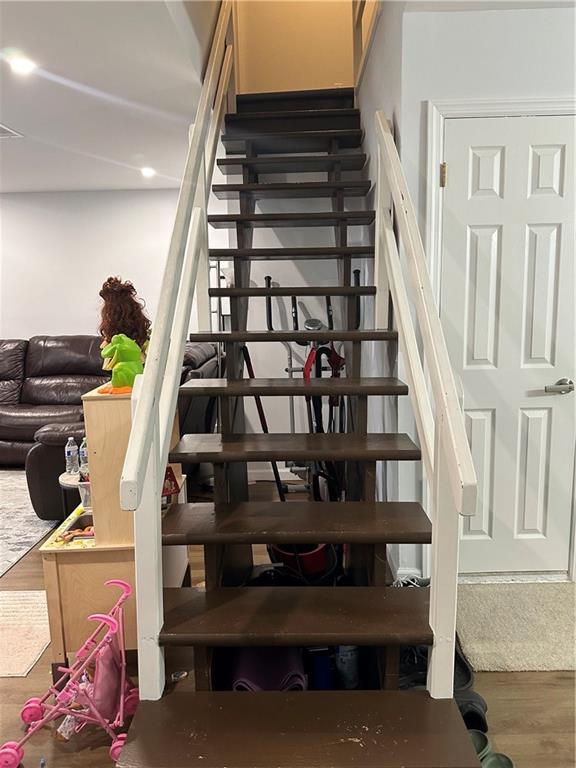 staircase with wood finished floors