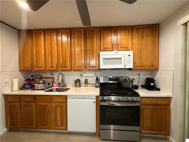 kitchen featuring white appliances, light tile patterned floors, decorative backsplash, and sink