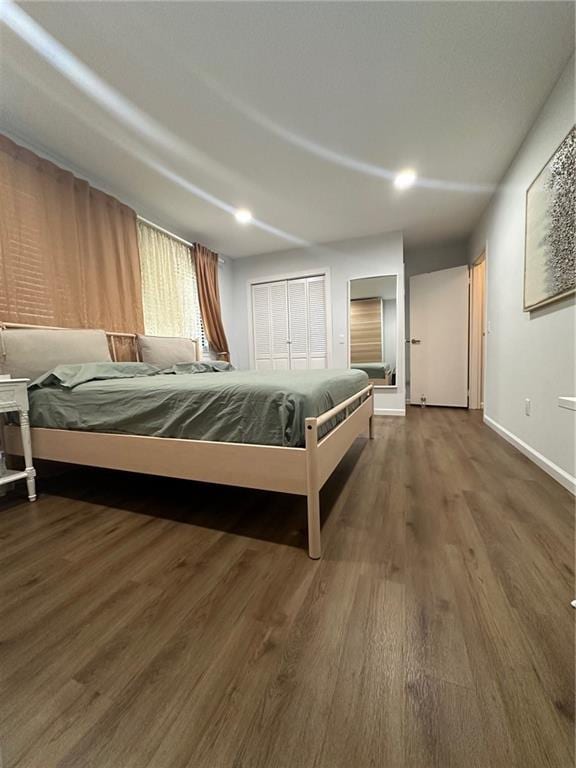 unfurnished bedroom featuring wood finished floors and baseboards