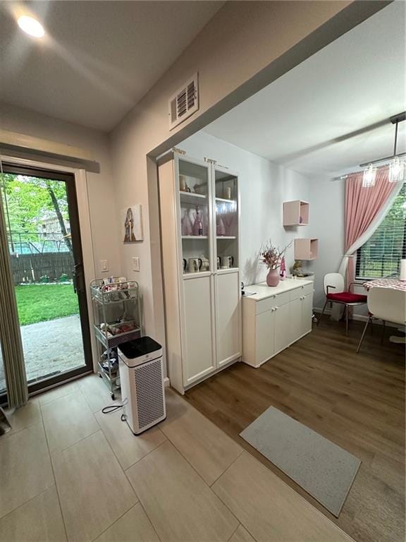 doorway to outside with visible vents and wood finished floors