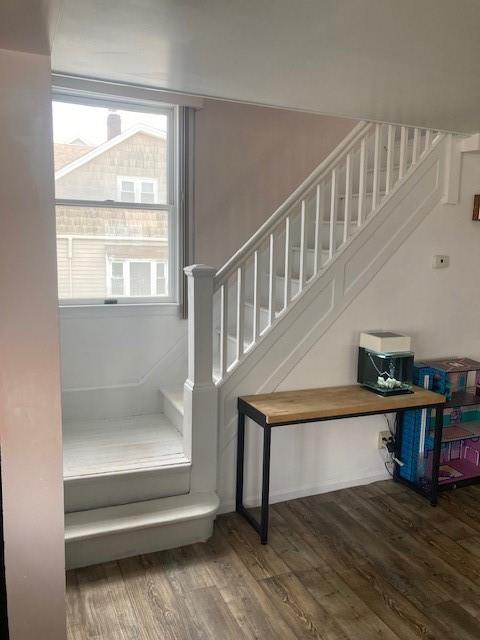 stairs with hardwood / wood-style flooring