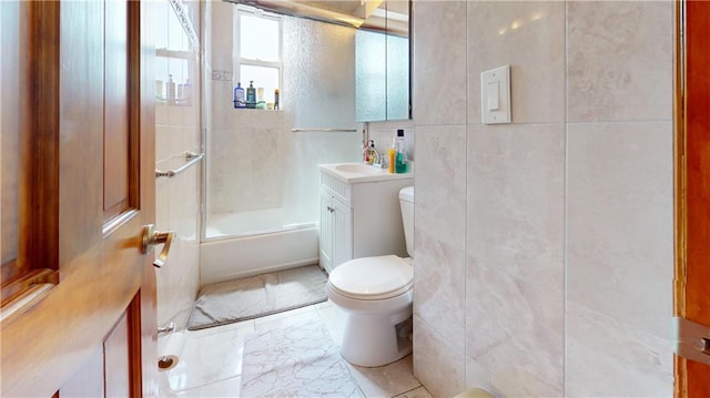 full bathroom with vanity, toilet, shower / bath combination with glass door, and tile walls