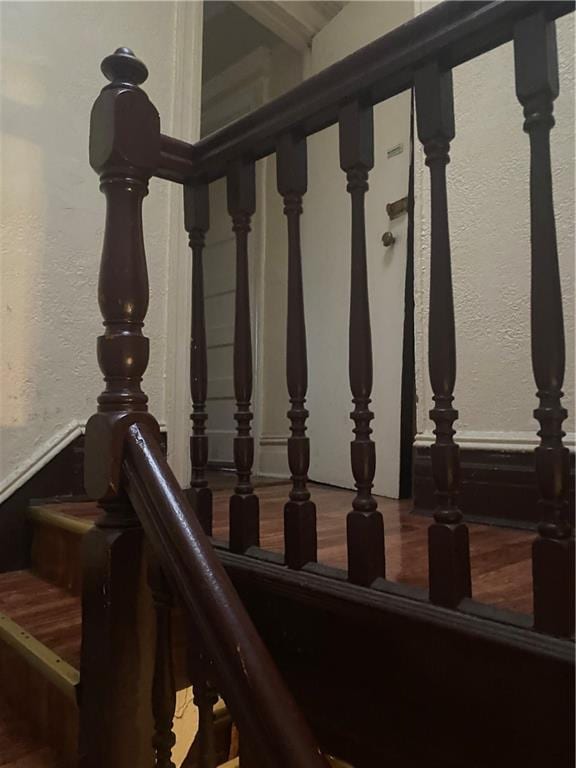 staircase featuring a textured wall