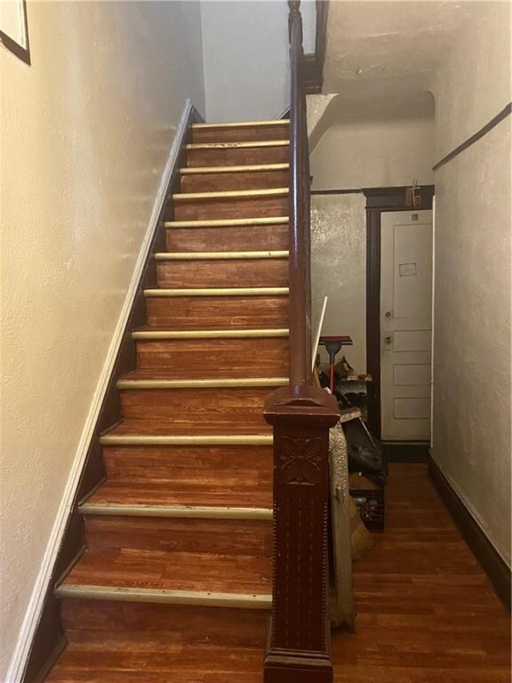 staircase featuring hardwood / wood-style flooring