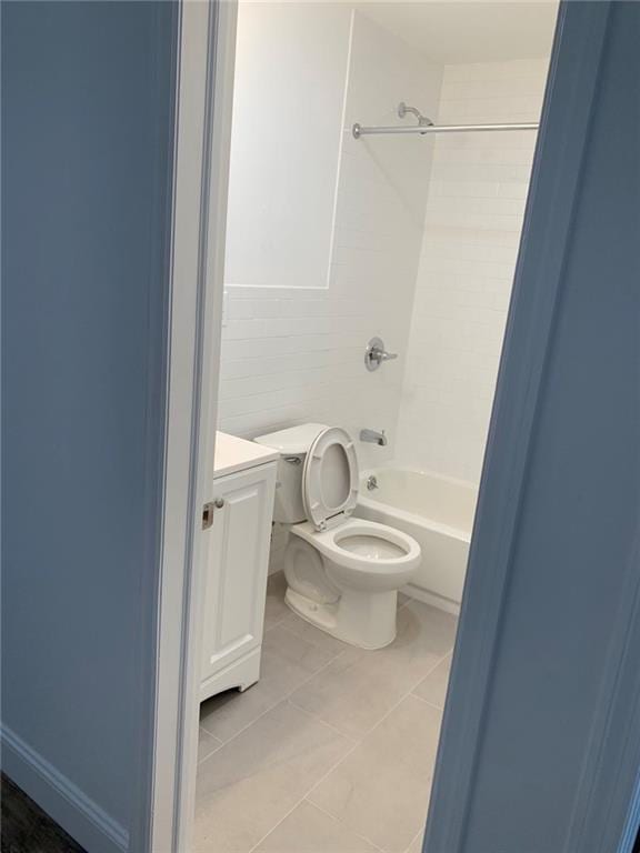 full bathroom with  shower combination, tile patterned floors, vanity, and toilet