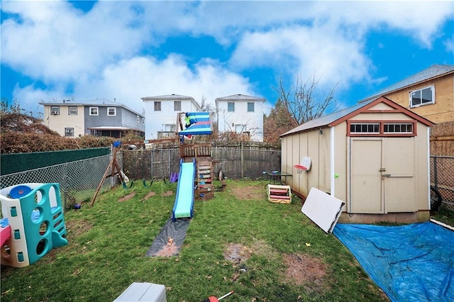 view of yard with a storage unit and a playground