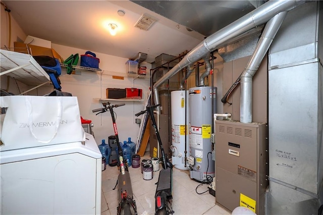 utilities with gas water heater and washer / dryer