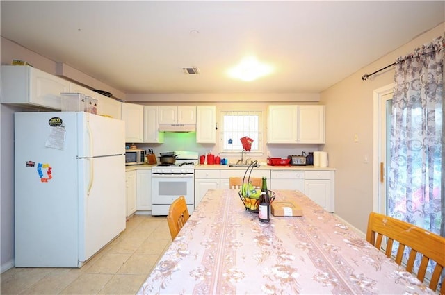 kitchen with sink, white cabinets, white appliances, and light tile patterned floors